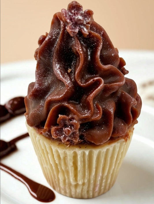Cupcake with chocolate frosting and flowers on a white plate