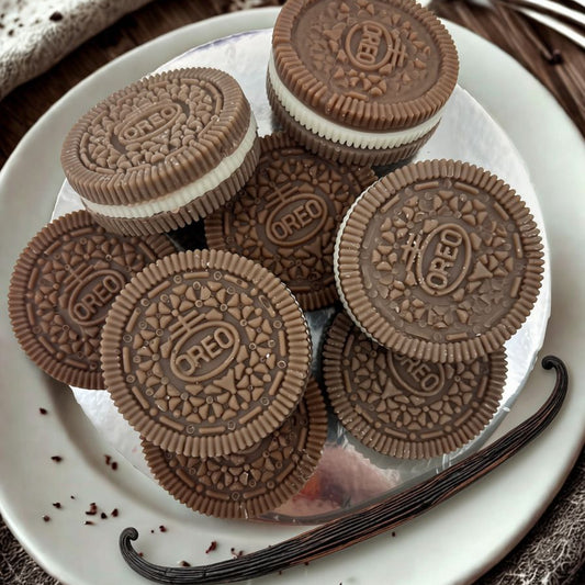 Stack of Oreo cookies on a white plate with a vanilla bean on a wooden surface