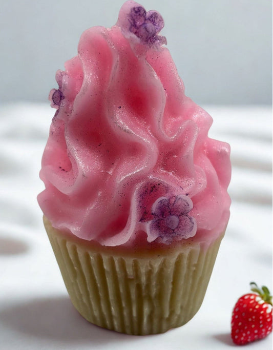 Cupcake-shaped soap with pink frosting and purple flowers on a white background